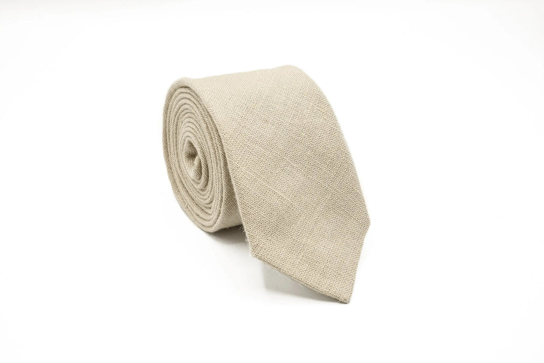 Stylish beige necktie for men, crafted from linen, paired with a matching pocket square.