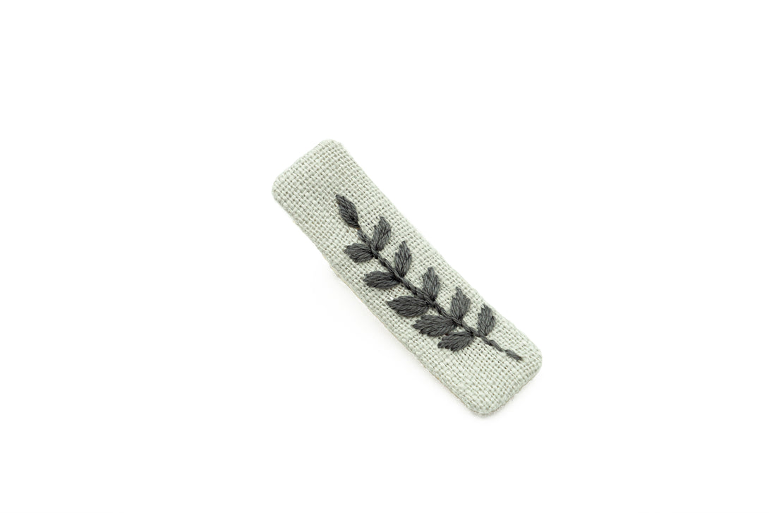 Elegant dusty gray linen hair clip with handcrafted leaf embroidery, sustainable and perfect for bridal parties, women, and young girls.