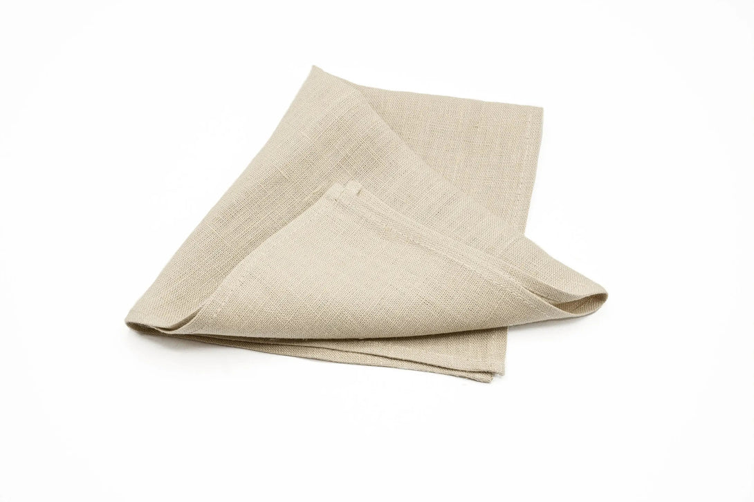 Beige linen pocket square folded for a sophisticated touch to men's wedding outfits.