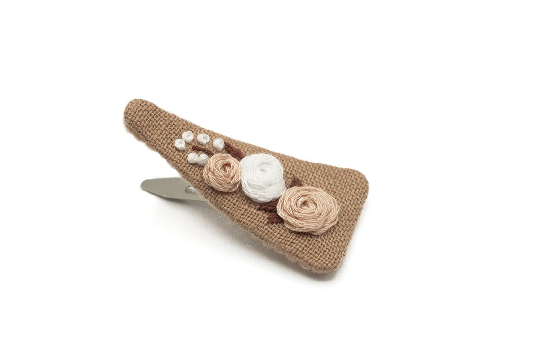 Handmade taupe fabric hair clip featuring delicate floral embroidery in mocha and white, eco-conscious packaging, perfect for stylish and sustainable hair accessories.