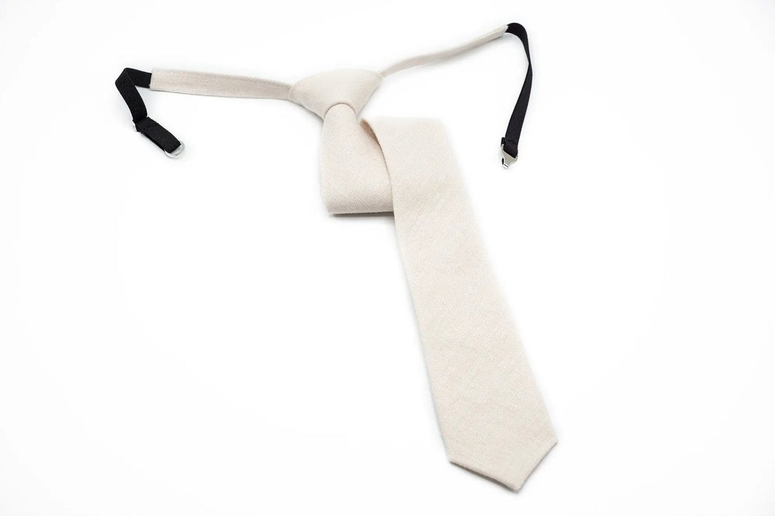 Ivory linen pre-tied necktie with a clean and minimalistic design, perfect for formal events and available with matching accessories.