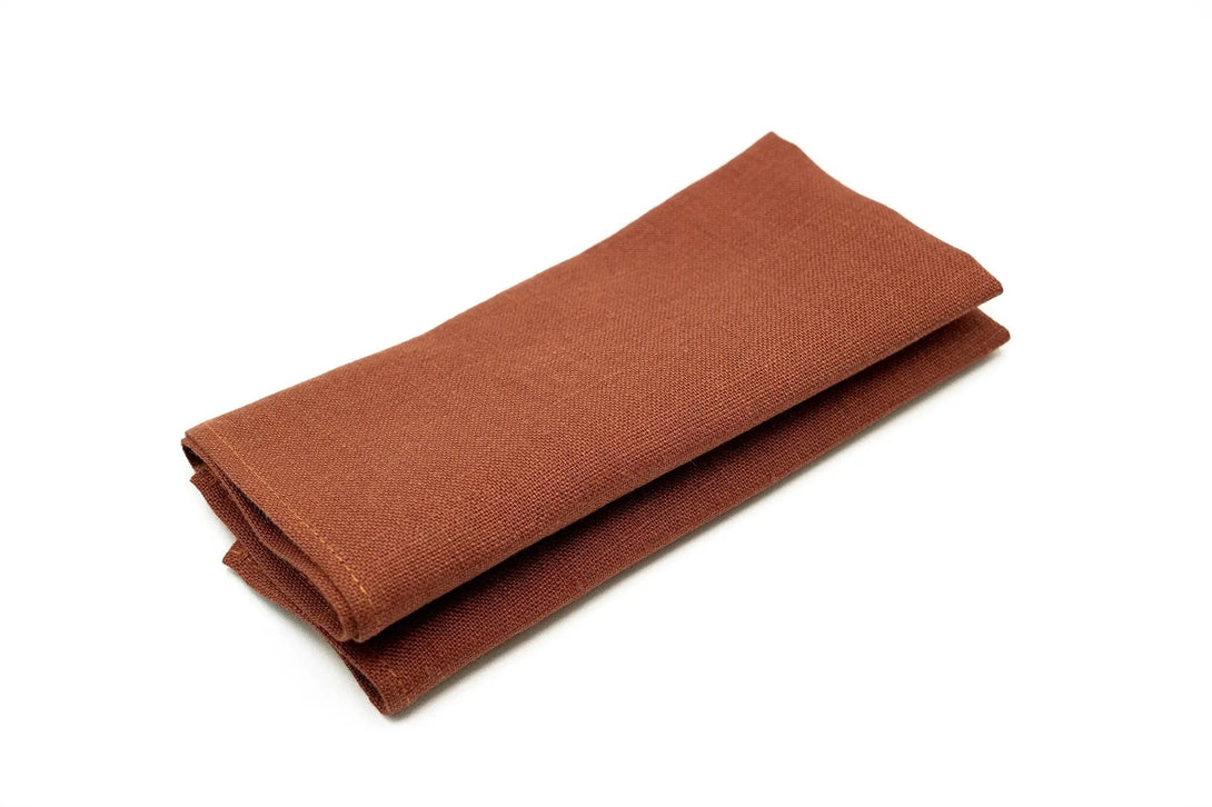 Folded rust linen pocket square for men’s suit, ideal for formal occasions