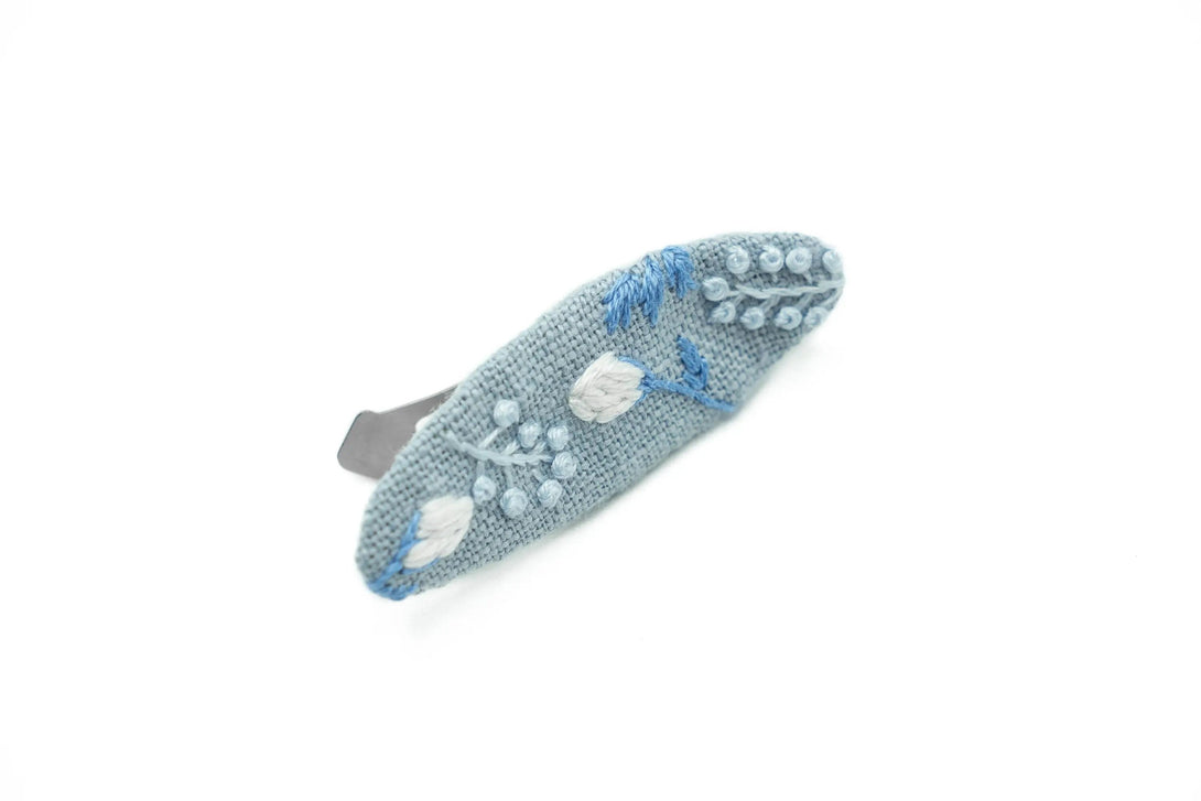 Dusty blue hair clip with delicate hand-embroidered floral designs, ideal for wedding parties, crafted by UrbaVana in eco-conscious packaging.