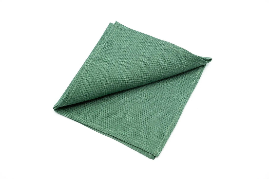 Dark sage green linen pocket square folded elegantly, ideal for weddings or formal attire