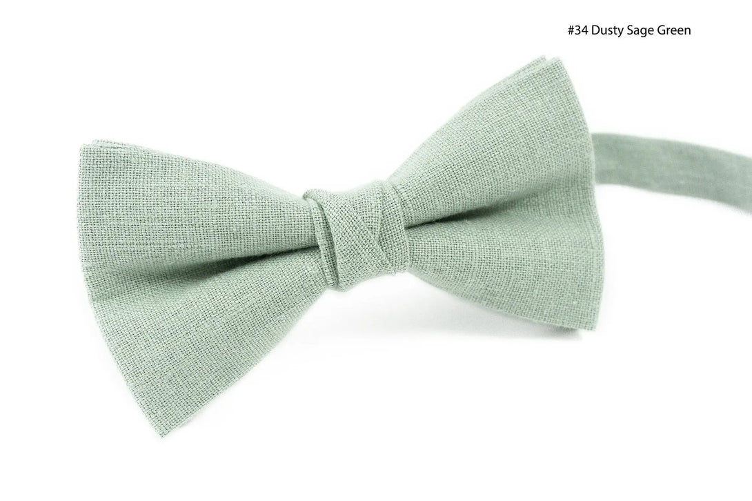 Father and son matching sage green bow ties with coordinating pocket squares in various shades.