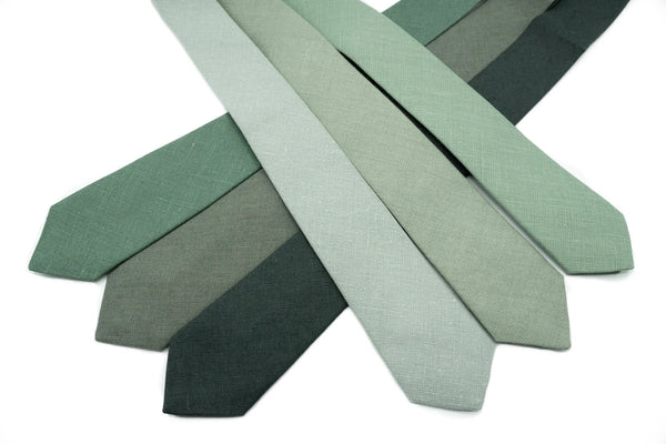 Stylish linen neckties in multiple green tones, including Dusty Sage, Pine, and Smoke Pine for weddings