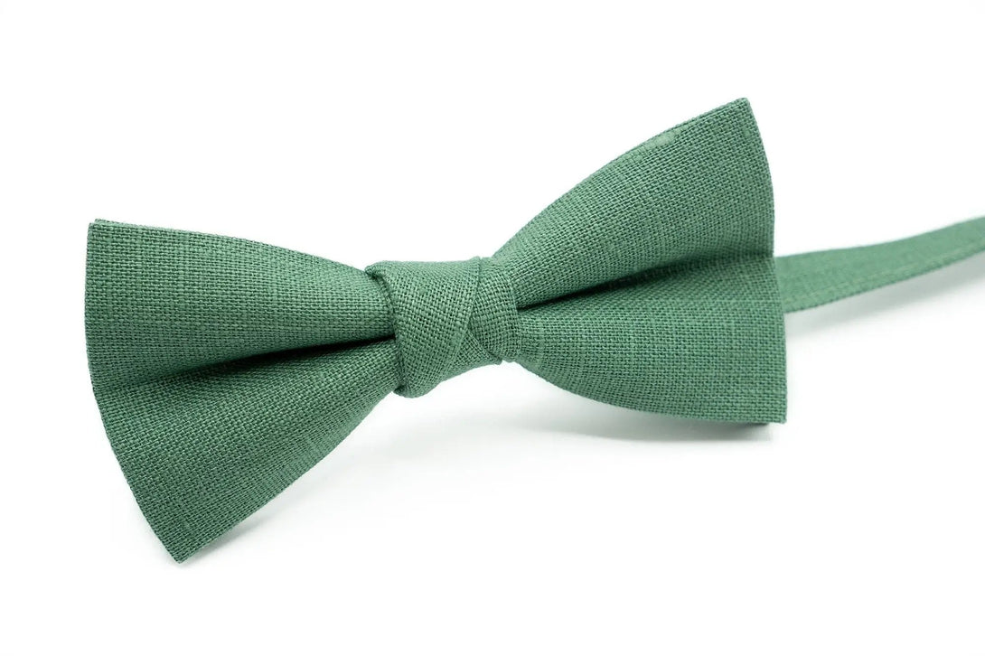 Stylish men's bow tie in Dark Sage Green linen fabric, paired with matching necktie and pocket square for a sophisticated look.