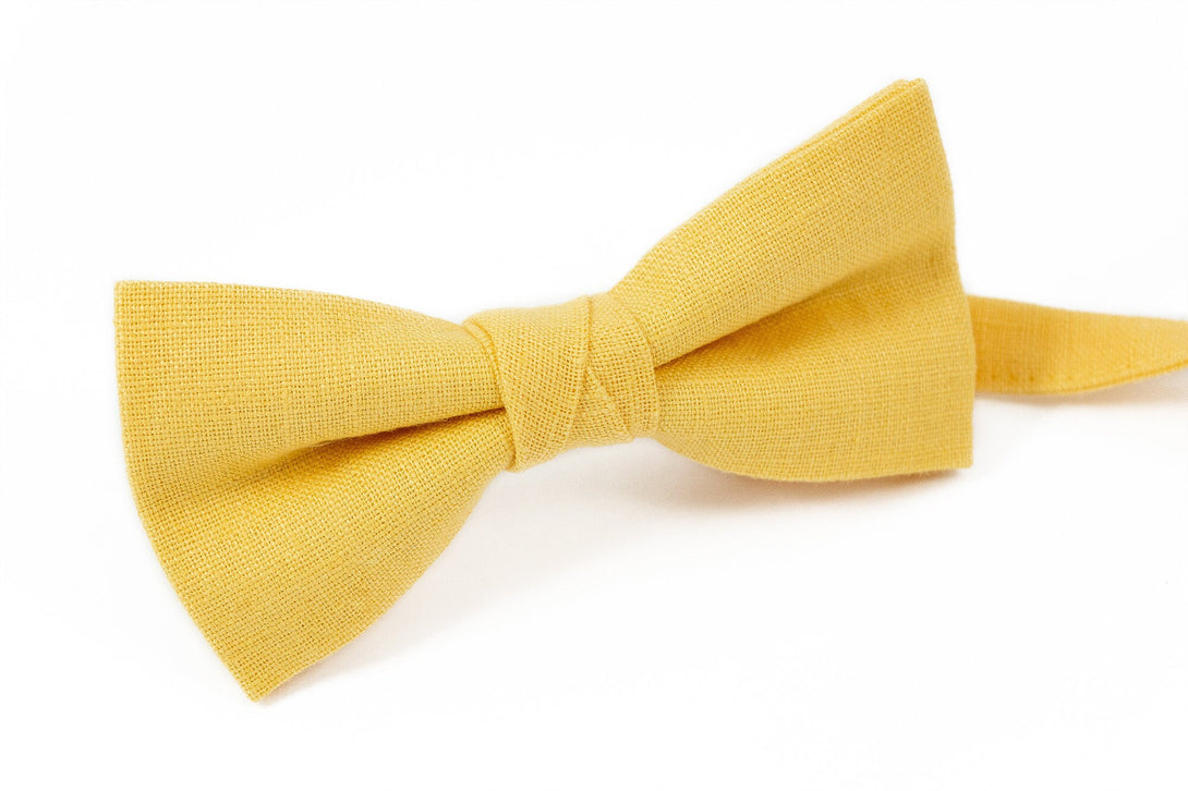 Yellow color pre-tied bow tie for groom or groomsmen on wedding day as unique gift from bride