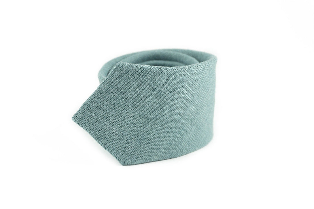 Mint gray linen groomsmen necktie, close-up, showcasing texture and craftsmanship, available with matching pocket square for weddings.